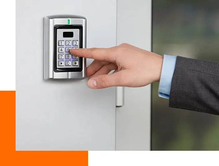 A person is using the keypad to open the door.