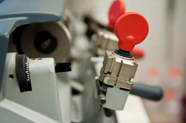 A close up of the red handle on a machine