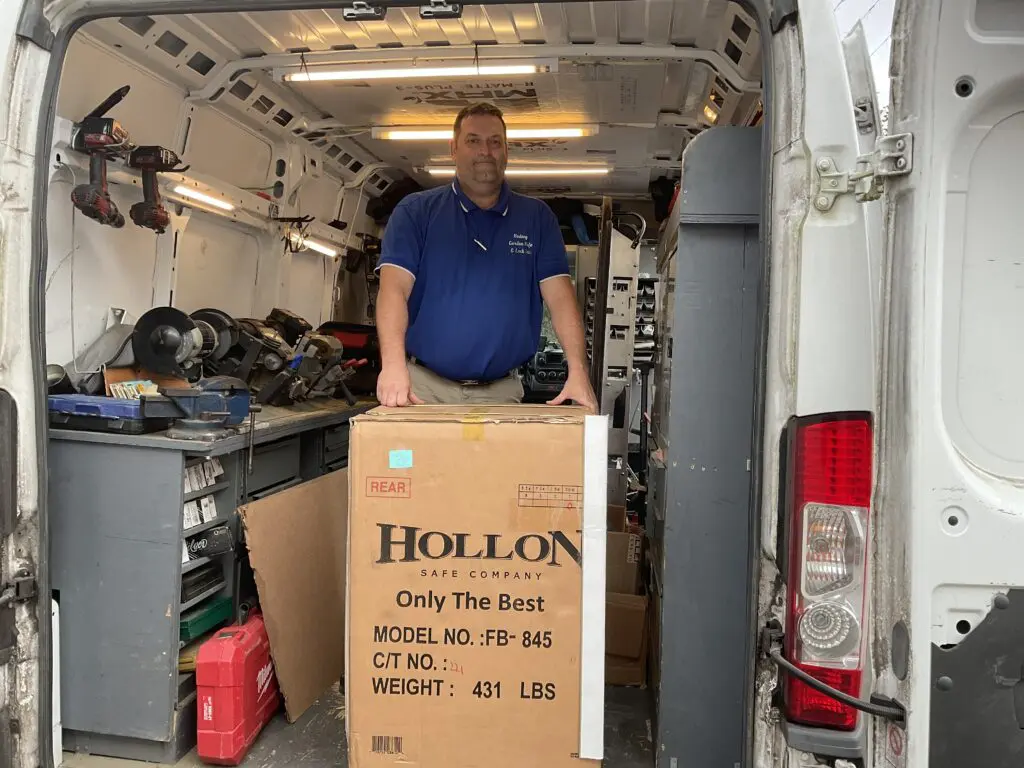 A man standing in the back of a truck with boxes.